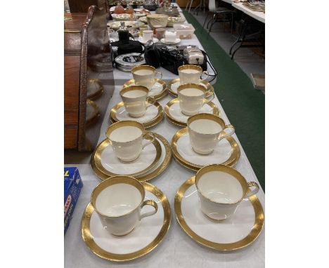 A QUANTITY OF NARUMI JAPANESE BONE CHINA CUPS, SAUCERS AND SIDE PLATES IN THE 'HARROW' PATTERN - WHITE WITH GILDED RIMS AND H
