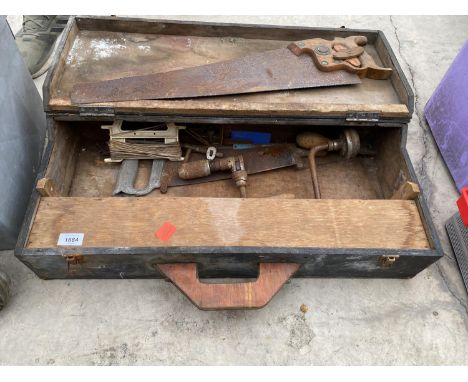 A VINTAGE WOODEN JOINERS CHEST WITH A SAW AND A BRACE DRILL 