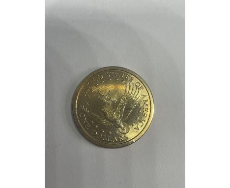 A YELLOW METAL COIN 