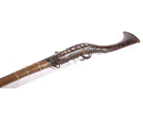 19th century North West Frontier flintlock musket or Jezzail with brass bound barrel, the stock carved and inlaid with mother