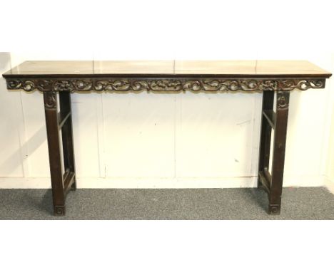 Early 20th century Chinese wood altar table with carved and pierced scroll and peach apron raised on straight end supports, 4