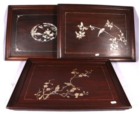 Set of three Chinese inlaid hardwood trays or panels, the mother of pearl inlays depicting confronting phoenix, bird amongst 