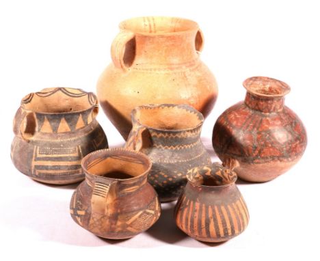 Group of six Neolithic painted pottery vessels including Banshan and Machang Majiayao wares, three twin handled pots with red