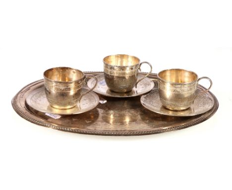 Set of three silver cups, three saucers and an oval tray to match, the preceding by Grinsell and other makers, Birmingham 188