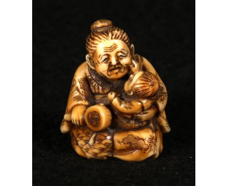 Japanese Meiji ivory netsuke depicting an old woman cradling a child and holding a drum, 3.5cm CONDITION REPORT: Crackle at h