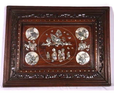 Chinese hardwood panel inset with abalone shell depicting figures in a landscape, held within a pierced and carved frame, 39c
