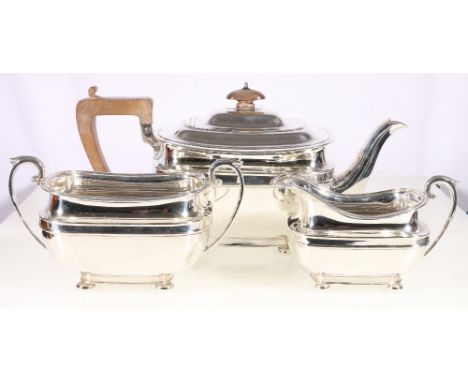 Silver three-piece teaset, of rectangular boat form, with moulded girdle on bun feet by George Howson, Sheffield 1936, 34oz.