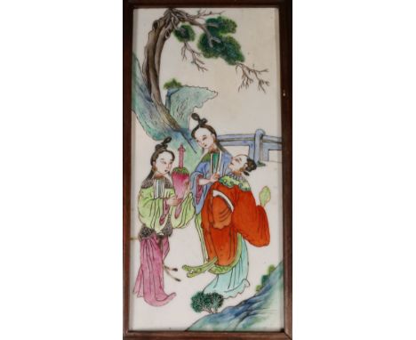 Early 20th century Chinese porcelain panel in a wooden frame, enamelled with a scene of three figures under a tree, suspensio