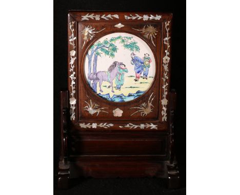 Late 19th Chinese table screen the rosewood frame inlaid with mother of pearl scrolling foliage, the stand pierced and carved