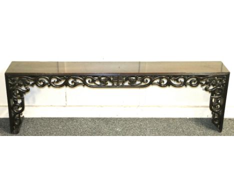 Early 20th century Chinese padouk wood wall bracket carved and pierced with peach and scroll decoration to the front, and pie