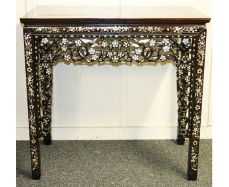 Chinese late 19th or early 20th century padouk wood table of rectangular form on a deep carved, pierced and mother of pearl i