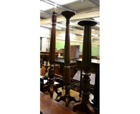 A Victorian mahogany torchere with boldly reeded upright (converted to a standard lamp) and two similar examples (one a.f.) 