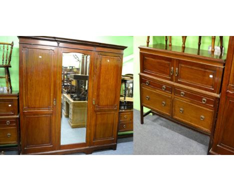 ^ A three piece bedroom suite comprising a mirrored wardrobe, a dressing table and a dressing chest 