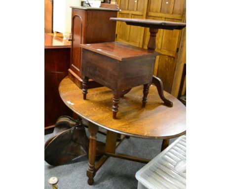 A 19th century mahogany tilt top tripod table, a pot cupboard, a commode together with a leather saddle (4) 