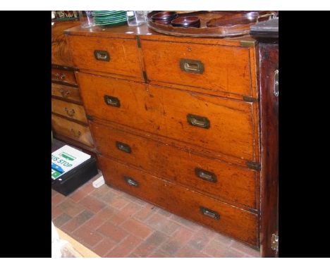 An antique campaign chest in two sections - having sunken  brass handles - 114cm wide CONDITION REPORTArmy and Navy button to