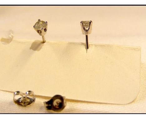 A pair of diamond stud earrings 