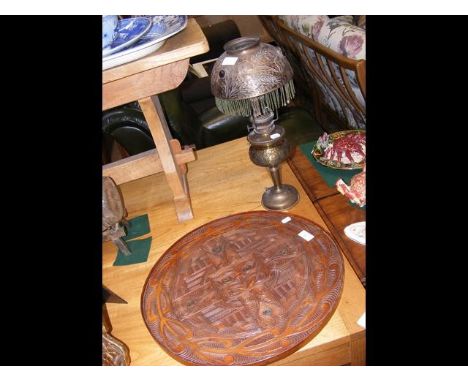 A 46cm diameter Middle Eastern serving tray, together with a 45cm high Middle Eastern table lamp 