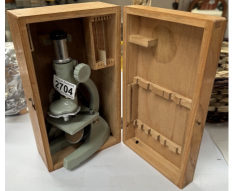 A childs mirrored microscope in a wooden box