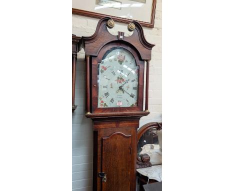 An early 19th Century oak longcase clock with mahogany cross banding, the hood, with swan neck pediment and turned columns, f