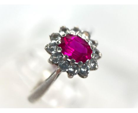 A white metal dress ring set with diamonds and central ruby, 2.2gm, size M-N