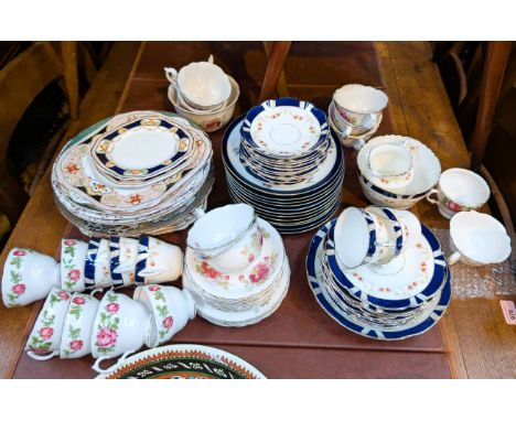 A floral and blue bordered china tea service and other dinner and teaware.