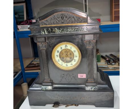 A large polished slate mantel clock, 8 day striking movement with revealed escapement, key and pendulum.