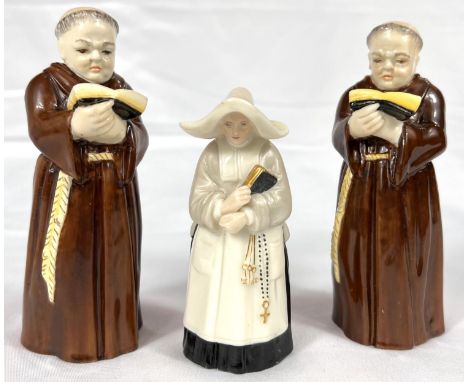 A pair of Royal Worcester monk candlesnuffers and a similar nun