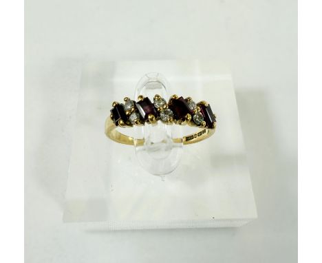 A 9 ct hallmarked gold ring set with alternating double diamond and baguette cut rubies, 1.8 gms, size "L".