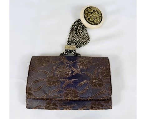 A Japanese silk purse with multi-strand chains from top attached to a roundel of simulated ivory and dragon motif central dis