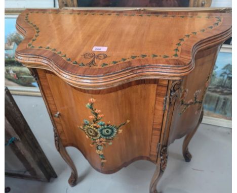 A reproduction Adams style drinks cabinet with hand painted floral decoration, serpentine front with hinged lid and fitted in