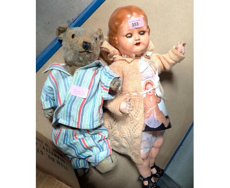 A vintage 1940's German girl doll; a vintage teddy bear, jointed legs and arms (both worn).