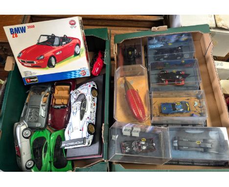 A collection of boxed Batmobiles and larger scale cars, etc.