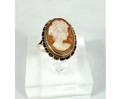A 9ct hallmarked gold ring set with a female head cameo, 3.5gms, size N.