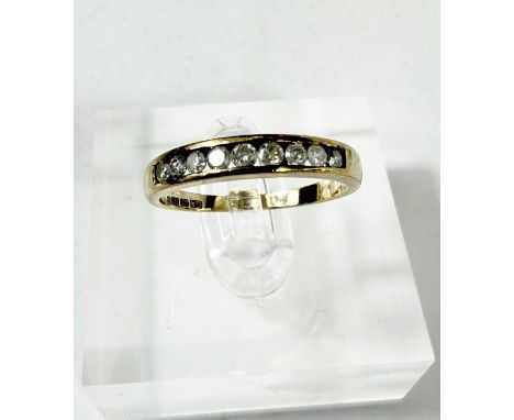 A 9 carat hallmarked gold eternity ring, set with 9 diamonds, 2gms, size 'M'.