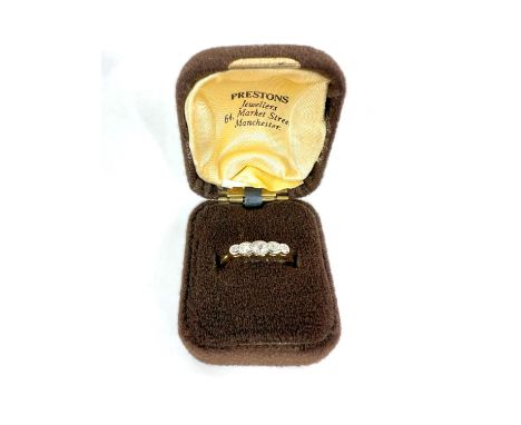 An 18ct gold five stone stone diamond ring in box