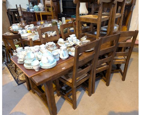 A period style oak dining suite comprising large refectory table, length 220cm and 6 (4+2) ladder back chairs with extensions