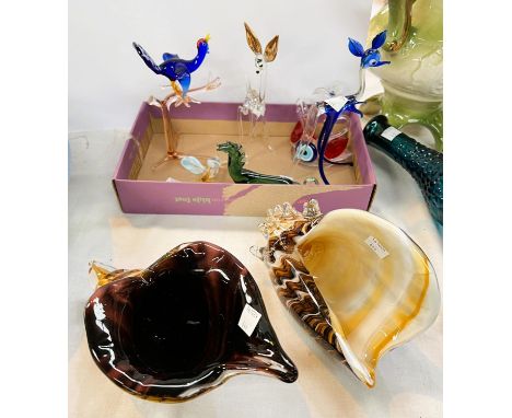 A collection of blown glass animals and three glass shells.