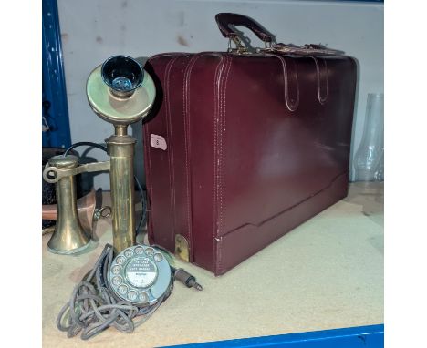 A leather carry bag; two vintage money boxes and a stick telephone.