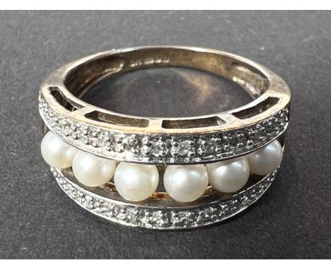 A pearl and diamond ring, 9ct hallmarked yellow gold, central row of 6 pearls with a row of small diamonds on each side, size