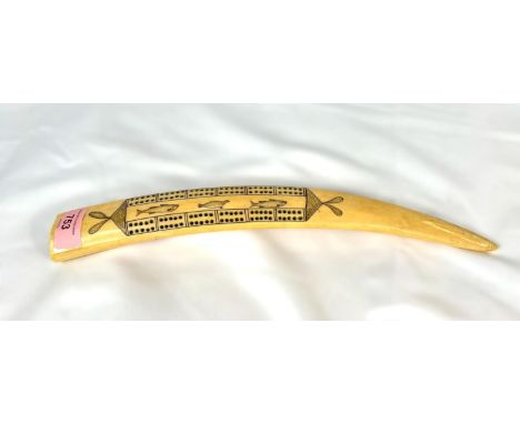 A 19th century North American Scrimshaw walrus tusk with cribbage board