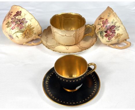 Royal Worcester: a gilded blak cabinet cup and saucer, another with peach ground and a further pair of cups