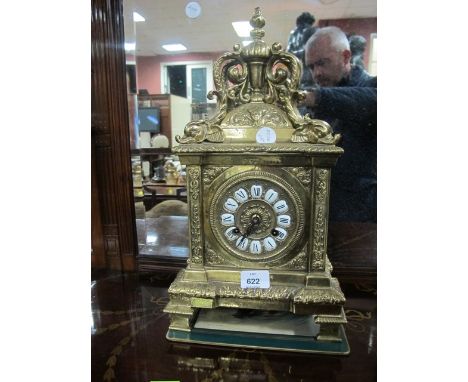 A BRASS MANTLE CLOCK the rectangular case surmounted with an urn supported by four dolphins above a circular dial with Roman 