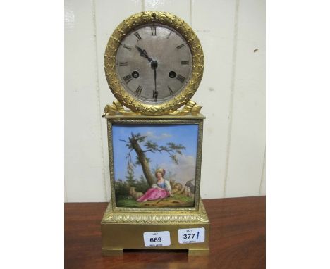 A FRENCH BRASS MANTLE CLOCK the circular silver dial with Roman numerals with a laurel wreath bezel and a rectangular painted