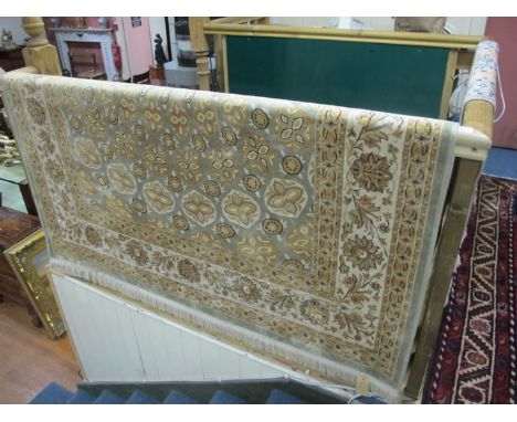 A SILK AND WOOL RUG the light green and beige ground with overall stylized floral panels within a conforming border 140cm x 1