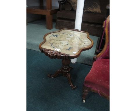 A VICTORIAN ROSEWOOD OCCASIONAL TABLE the shaped top with needlework panel raised on baluster support and tripod base with sc