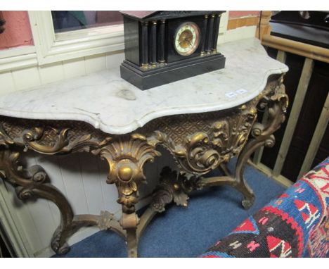 A CONTINENTAL GILTWOOD AND GESSO CONSOLE TABLE of serpentine outline surmounted with white vein marble top above a foliate sc