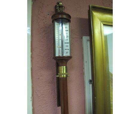 A GOOD WALNUT AND BRASS MOUNTED BAROMETER AND THERMOMETER of cylindrical form 93cm (h)