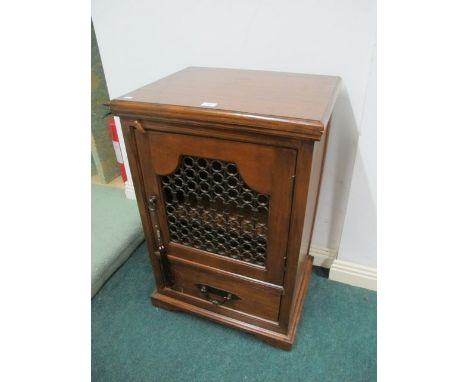 A MEXICAN HARDWOOD SIDE CABINET the rectangular top with grill door and drawer on bracket feet 92cm (h) x 61cm (w) x 49cm (d)