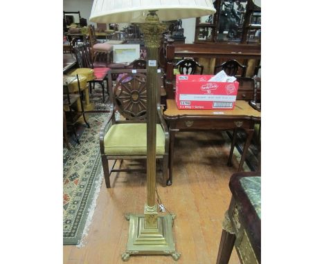 A BRASS FLOOR STANDARD LAMP the reeded column with corinthian capitals raised on square stepped base with claw feet