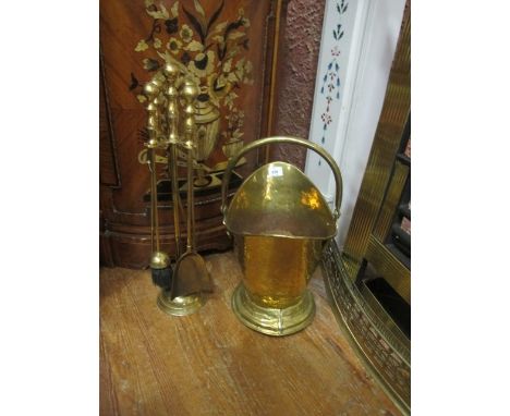 A BRASS COMPANION SET together with a brass swing handle coal helmet (2)